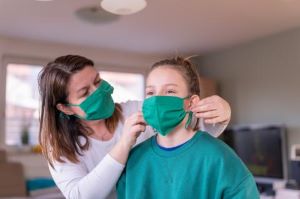 Mother and daughter trying on masks
