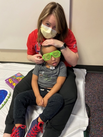 Jena Aebi, speech-language pathologist, and LJ acting cool during therapy.