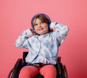 Child in wheelchair with headphones on