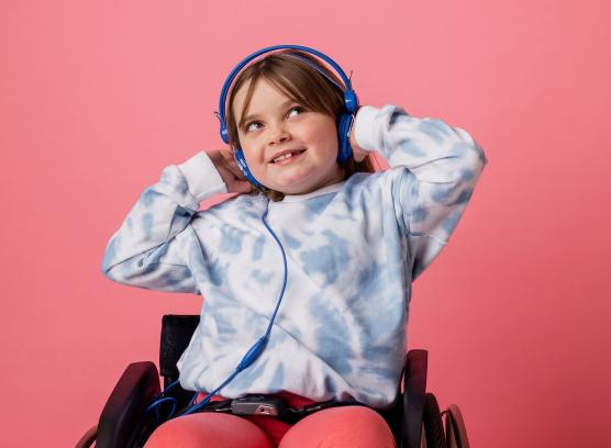 Child in wheelchair with headphones on