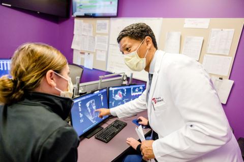 Dr. Wayne Franklin showing colleague an image on the computer