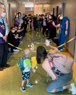 Toddler leaving hospital as providers wave good bye