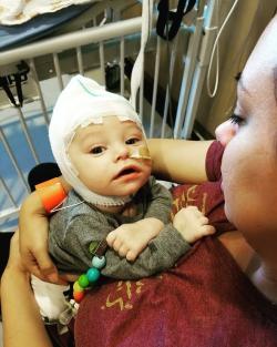 Mother holding baby in hospital room
