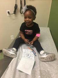 Toddler sitting on exam table