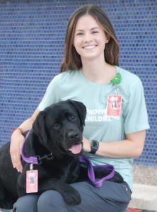 Black pet therapy dog and female handler