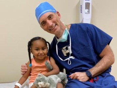 Provider in scrubs next to young patient