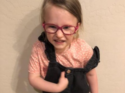 Smiling child in pink glasses