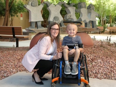 Boy in wheelchair, next to provider