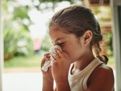 Girl blowing her nose