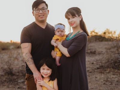 Family photo of mother, father and two young children in desert