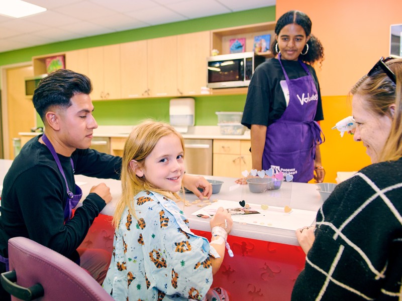 Volunteers making crafts with child