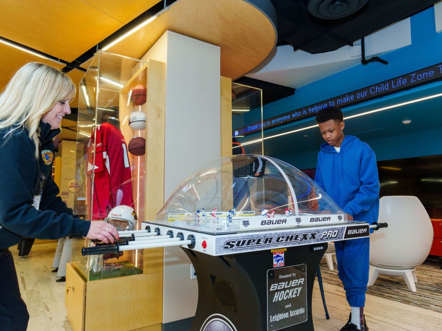 Woman and boy playing foosball