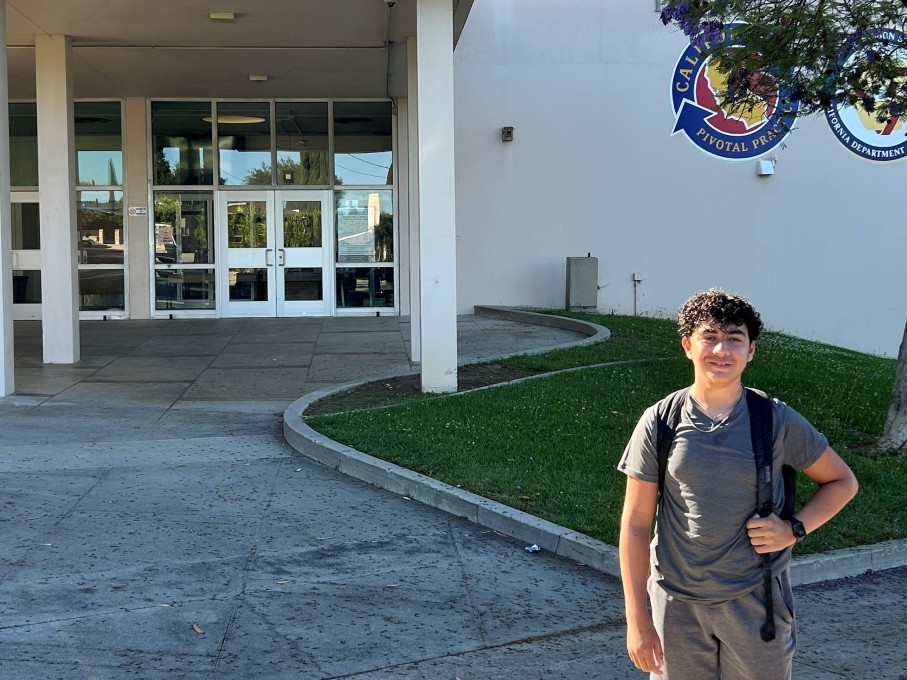 Teen boy smiling outside of high school